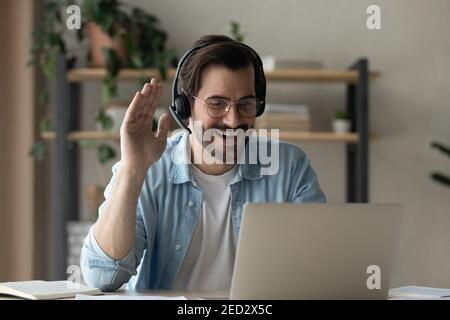 Young guy student practice foreign language with native speaker online Stock Photo