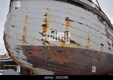 Old weathered boat hull with damage to paintwork and rust marks Stock Photo