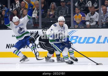 Oct 13, 2015; Los Angeles, CA, USA;  Los Angeles Kings left wing Kyle Clifford (13) chases down Vancouver Canucks defenseman Dan Hamhuis (2) as Vancouver Canucks right wing Derek Dorsett (15) falls on the ice in the first period of the game at Staples Center. Mandatory Credit: Jayne Kamin-Oncea-USA TODAY Sports  / Reuters  Picture Supplied by Action Images   (TAGS: Sport Ice Hockey NHL) *** Local Caption *** 2015-10-14T033247Z 951872494 NOCID RTRMADP 3 NHL-VANCOUVER-CANUCKS-AT-LOS-ANGELES-KINGS.JPG