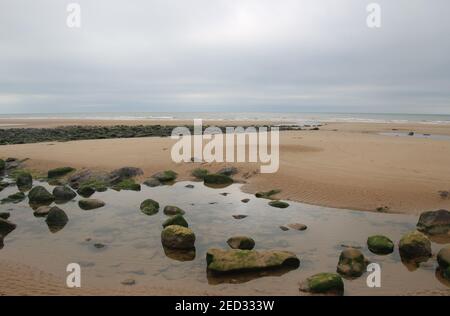 Sandy beach and rocks in St Bees. On the west coast of England, near Lake District. North-west Europe. Stock Photo