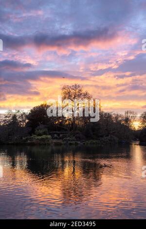 Sunset and reflections over Boating Lakes, Battersea Park, London, 3 February 2021 Stock Photo
