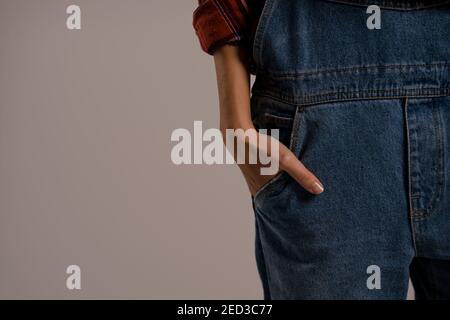 Close up photo of farmers look style. Denim overall and plaid shirt . Stock Photo