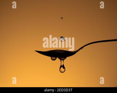 Water drops on spoon, splashes. Stock Photo