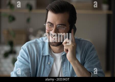 Happy handsome young guy enjoy phone conversation with pleasant person Stock Photo