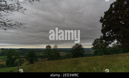 dark structured clouds over eifel landscape in the morning, Germany Stock Photo