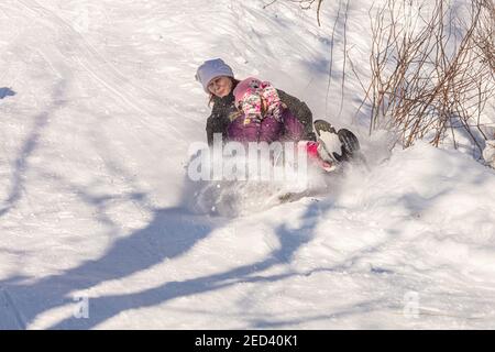 Helsinki Finland 14 February 2021. People are sledging down the mountain. Celebrate Friend's Day. High quality photo Stock Photo