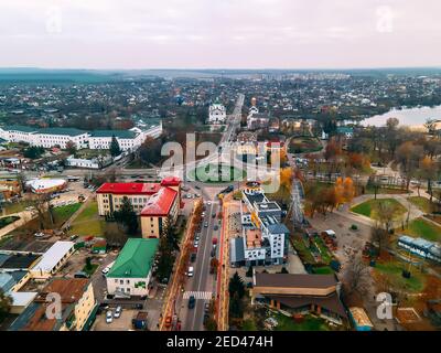 Aerial view of roundabout road with circular cars in small european city at autumn cloudy day, Kyiv region, Ukraine Stock Photo
