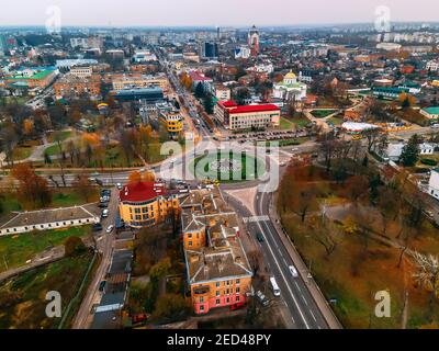 Aerial view of roundabout road with circular cars in small european city at autumn cloudy day, Kyiv region, Ukraine Stock Photo