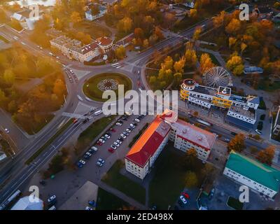 Aerial view of roundabout road with circular cars in small european city at autumn sunset, Kyiv region, Ukraine Stock Photo