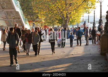 People walking along the riverside embankment in the afternoon sun, South Bank, London Stock Photo
