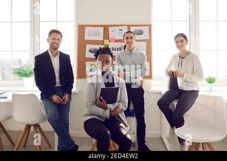 Portrait of multiracial office workers smiling looking at camera in modern business center office. Stock Photo