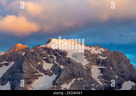 Sunlight at sunset on the Marmolada massif. Punta Penia peak, glaciers. The Dolomites. Italian Alps. Europe. Stock Photo