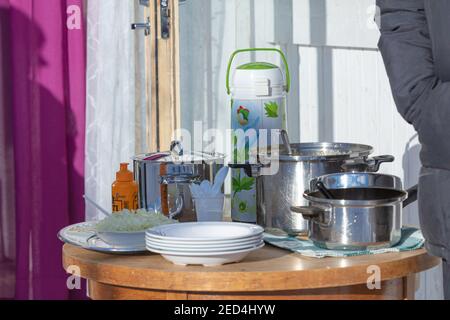 Helsinki Finland 14 February 2021. Mustard in a yellow tube casserole with pea soup, plates, on the table. A treat for guests. High quality photo Stock Photo