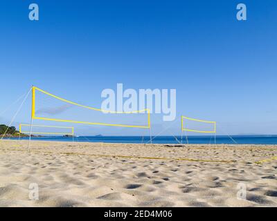 Yellow beach volleyball nets erected for use with no players yet on Mount Maunganui Main beach. Stock Photo