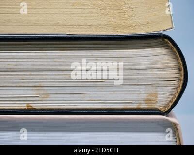 Close up with three thick stacked books Stock Photo