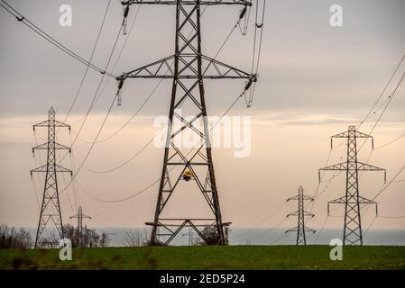 Brighton, February 14th 2021: Electrical pylons in Mile Oak in East Sussex Credit: Andrew Hasson/Alamy Live News Stock Photo