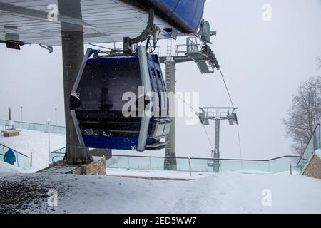 Winter holiday on a snowy day. Ropeway station and cabin at Tufandag Resort in snowy day. Gabala - Azerbaijan Stock Photo