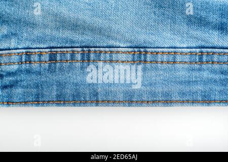 Stitching on jeans. Denim blue. Seam on fabric. Stock Photo