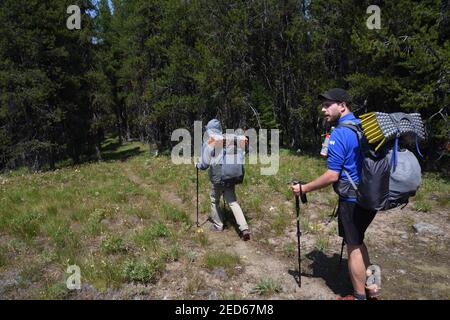 Nick and Paddy from England hiking the Pacific Northwest National Scenic Trail. Purcell Mountains, northwest Montana. (Photo by Randy Beacham) Stock Photo