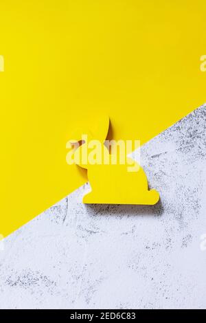 Minimal Easter concept. Yellow bunny on Illuminating Yellow and Ultimate Gray Color of the year 2021. Top view flat lay background. Copy space. Stock Photo