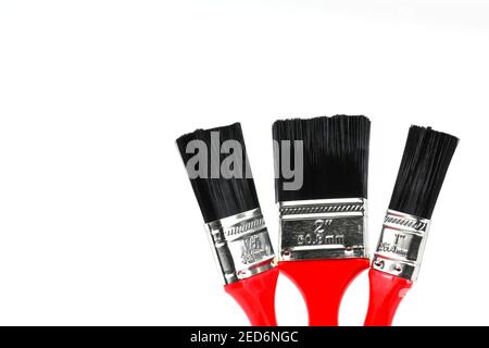 Three paint brushes of different sizes on a plain white background. No people. Copy space. Stock Photo