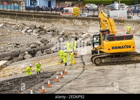 PORTHCAWL, WALES - JUNE 2018: Construction operatives working on the redevelopment of the seafront in the centre of the town's promenade Stock Photo