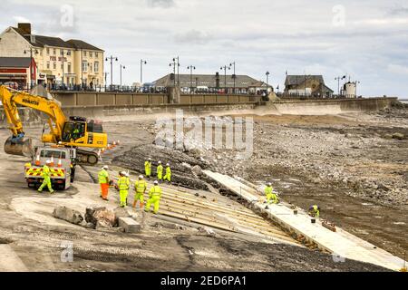 PORTHCAWL, WALES - JUNE 2018: Construction operatives working on the redevelopment of the seafront in the centre of the town's promenade Stock Photo