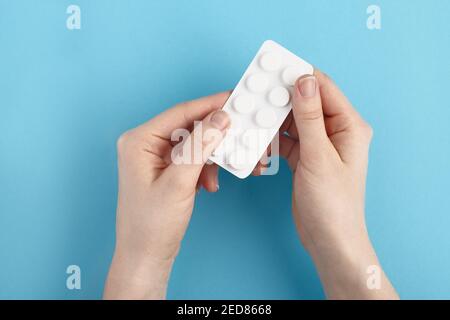 White blister pack of medicine pills in a hands. Heap of pills - medical background Stock Photo
