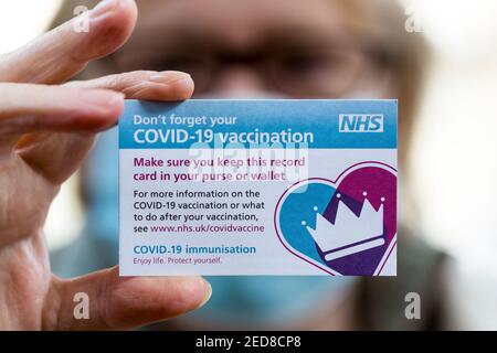 NHS COVID-19 vaccination record card given to patients after they have been vaccinated. Stock Photo