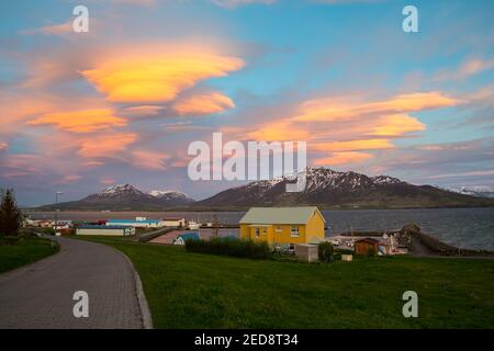 The sunset is reflected in the clouds near island of Hrisey in Iceland Stock Photo