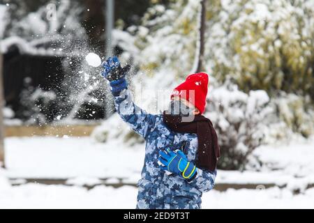 Tirana, Albania. 14th Feb, 2021. A kid throws a snowball at a park in Tirana, Albania, on Feb. 14, 2021. Credit: Gent Onuzi/Xinhua/Alamy Live News Stock Photo