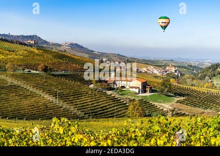 Hot Air Balloon flying over the beautiful landscape of Langhe vineyards. Barolo, Piedmont, Italy, October 2020 Stock Photo