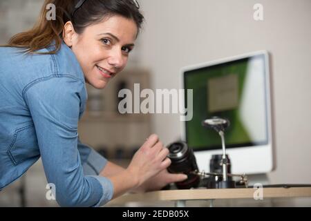 woman engineer repairing camera lens Stock Photo