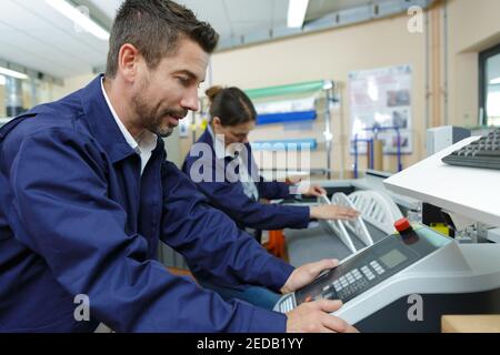 engineer using a machine machine Stock Photo