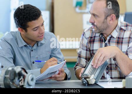two male masters work in the workshop Stock Photo