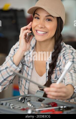 female on the phone fixing a computer Stock Photo