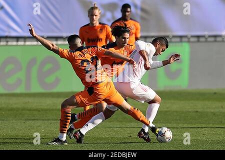 Madrid, Spain. 14th Feb, 2021. Real Madrid's Casemiro (R) vies with Valencia's Maxi Gomez (L) during a Spanish football league match between Real Madrid and Valencia CF in Madrid, Spain, on Feb. 14, 2021. Credit: Edward F. Peters/Xinhua/Alamy Live News Stock Photo