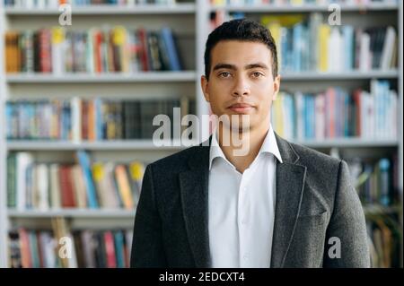 Close-up portrait of confident businessman, student or tutor, indoors. Influential successful hispanic man in formal wear at looks at the camera, show self confidence Stock Photo