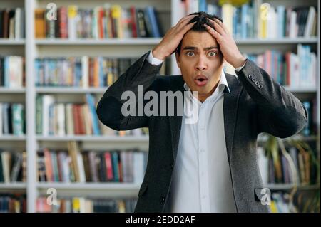 Portrait of confused businessman or student in formal wear. Surprised employee looking at the camera, get an unexpected news Stock Photo