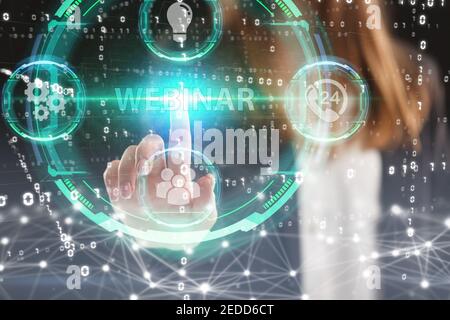 Business, Technology, Internet and network concept. Young businessman working on a virtual screen of the future and sees the inscription: Webinar Stock Photo