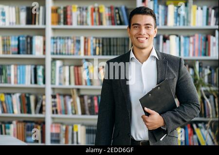 Portrait of handsome successful hispanic man dressed in formal stylish suit and looking directly at the camera. Confident business mentor, manager or entrepreneur Stock Photo