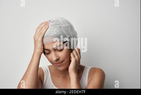 woman's bandaged head injury health problem medicine Stock Photo