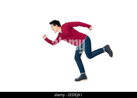 Young energetic Asian man in casual clothes running studio shot isolated on white background Stock Photo