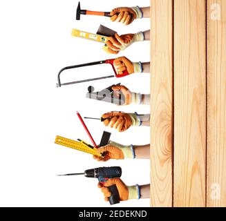 Male hands with different construction tools and wooden surface on white background Stock Photo