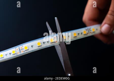 cutting led strip with scissors,installation of a diode tape Stock Photo