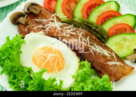 Fried eggs with bacon and fresh vegetables. Healthy and delicious breakfast made from vegetables with empty space for text (copy space) Stock Photo