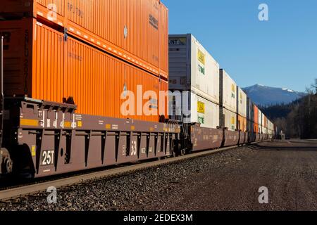 A line of intermodal container well cars through the BNSF rail yard in ...