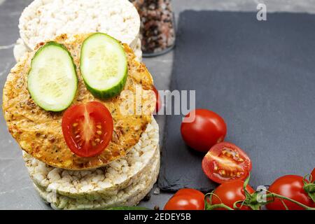 Rice cakes and fresh vegetables cherry tomatoes and cucumber. Canape with rice cake and cucumber Stock Photo