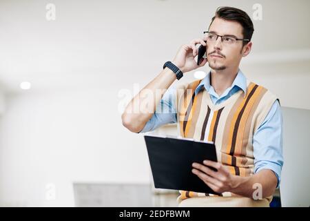 Pensive businessman talking on phone Stock Photo