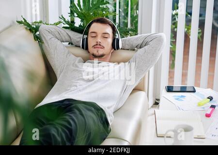Man relaxing on sofa Stock Photo